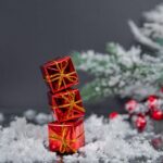Christmas tree decorations in the form of gifts against in a gray background.