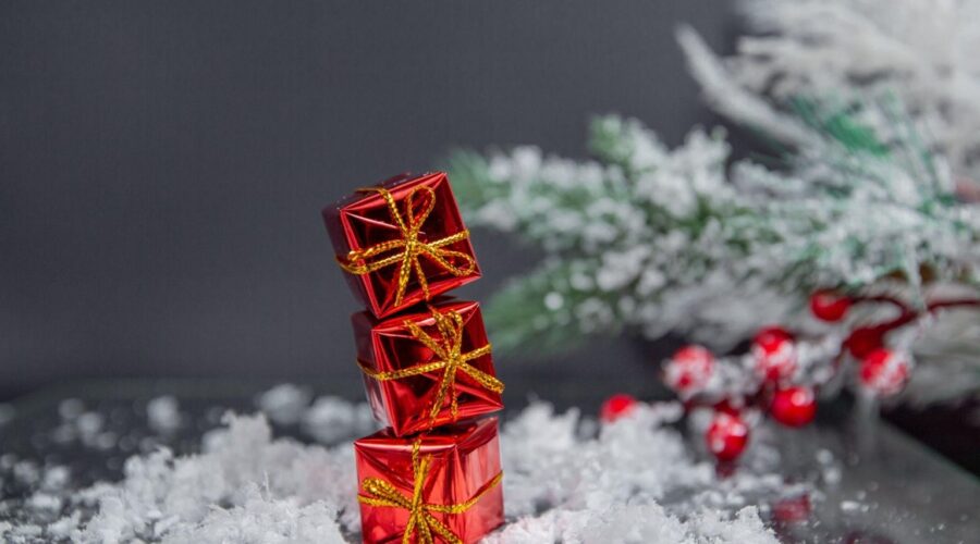 Christmas tree decorations in the form of gifts against in a gray background.